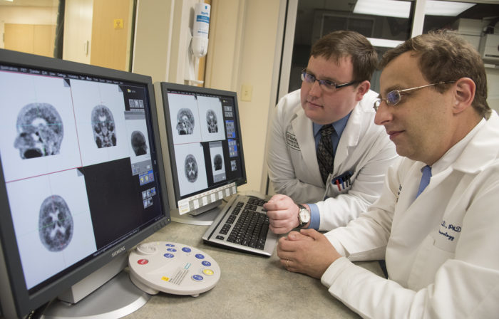 Study authors Beau M. Ances, MD, PhD, (right) associate professor of neurology at Washington University School of Medicine in St. Louis, and Matthew R. Brier, an MD/PhD student at the university, examine PET (positron emission tomography) scans of Alzheimer’s disease patients. 