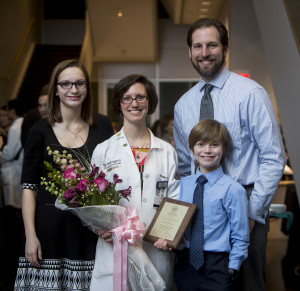 Amanda R. Emke, MD, with her family at the Distinguished Faculty Awards ceremony Feb. 17, was awarded a Samuel R. Goldstein Leadership Award in Medical Student Education.