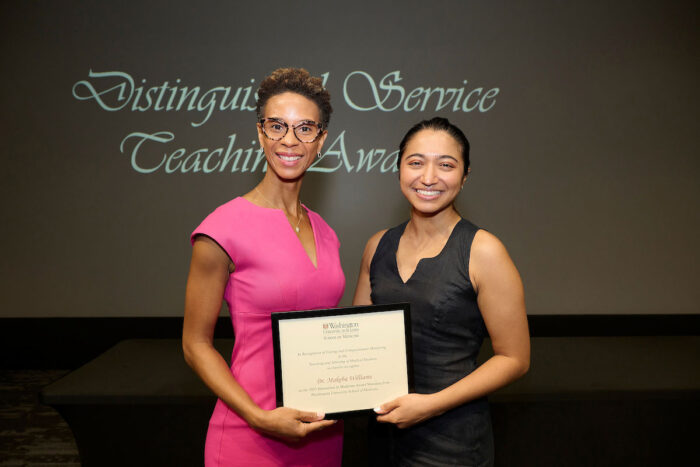 Makeba Williams accepts the Humanism in Medicine award from Isabella Gomes.