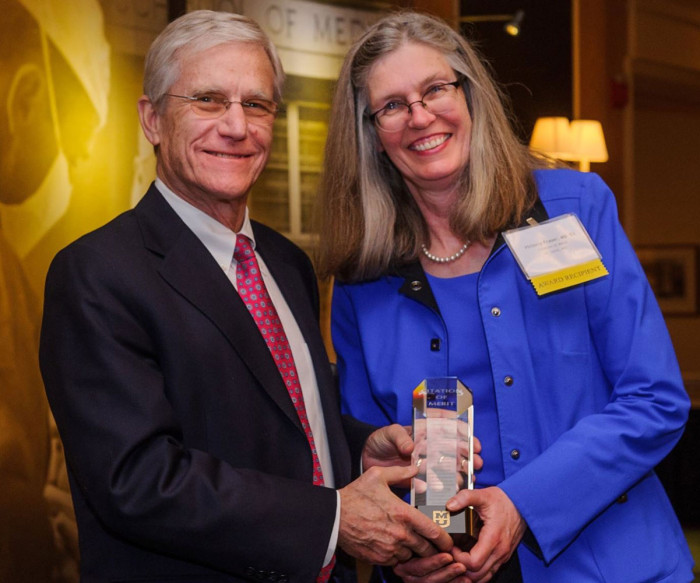 Patrice Delafontaine, MD, dean of the University of Missouri School of Medicine, presents Victoria J. Fraser, MD, head of the Department of Medicine at Washington University, with the Citation of Merit from the University of Missouri.