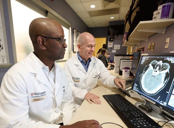 Opeolu Adeoye, MD, and Peter Panagos, MD, both professors of emergency medicine at Washington University School of Medicine in St. Louis, analyze a brain scan for stroke damage.