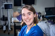 WashU medical student Caellagh Catley wearing blue scrubs in a mock operating room