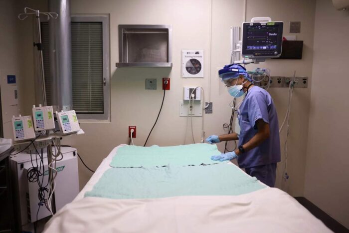 Intensive Care Unit nurse Subramanya Kirugulige prepares a bed for an arriving COVID-19 patient at Roseland Community Hospital in Chicago in December.