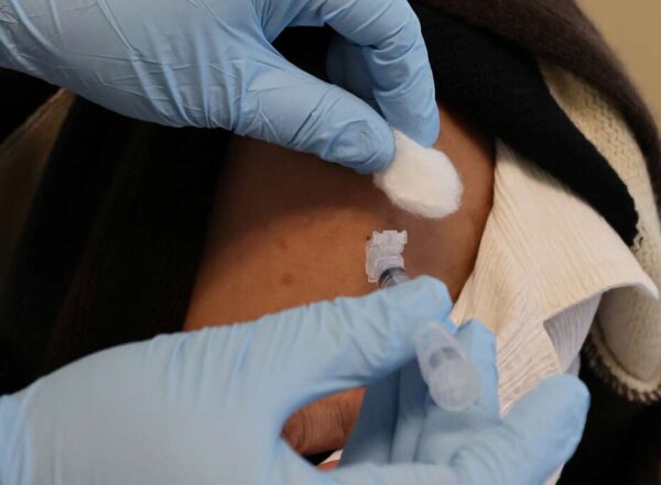 Closeup photo of someone receiving a vaccination in upper arm