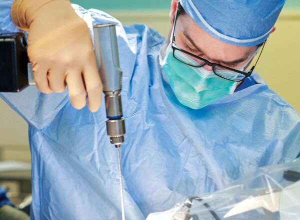 Eric Leuthardt, MD, performs brain surgery, inserting a small laser probe with the assistance of an intraoperative robotic system.