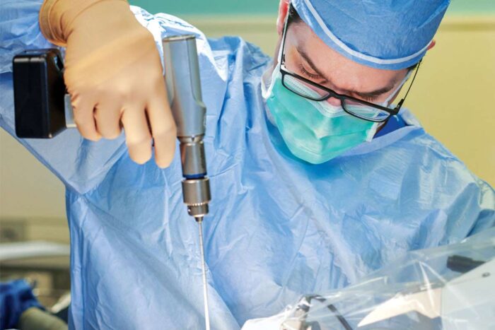 Eric Leuthardt, MD, performs brain surgery, inserting a small laser probe with the assistance of an intraoperative robotic system.