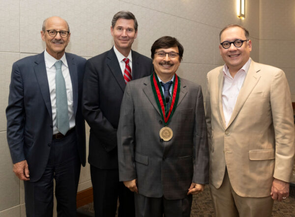 From left, David H. Perlmutter, MD, the George and Carol Bauer Dean of the School of Medicine; Nupam Mahajan, PhD; John A. Olson Jr., MD, PhD, head of the Department of Surgery; and Chancellor Andrew J. Martin.