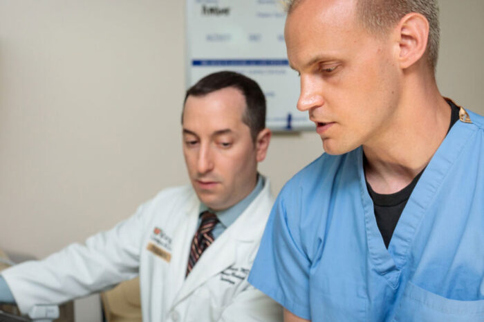 Medical student Weston McCarron (right), practices performing an ultrasound with Evan Schwarz, MD