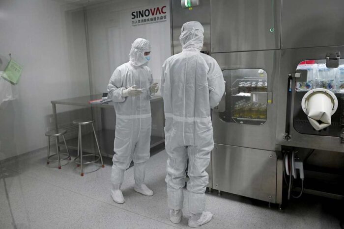 Researchers in full body PPE Inside Sinovac Biotech’s factory in Beijing in September.