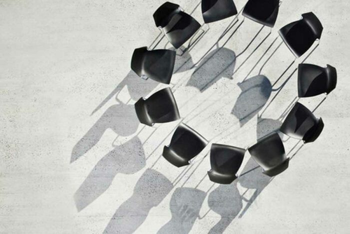 11 black chairs form a circle